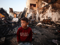 A Palestinian boy looks at the site of an Israeli strike on tents sheltering displaced people amid the Israel-Hamas conflict at Al-Aqsa Mart...