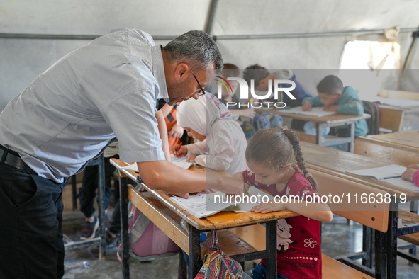 With The Approach Of Winter, Students In The Deir Ballut Camp In Rural Aleppo Study In A School Made Up Of Torn Tents, on october 13, 2024.