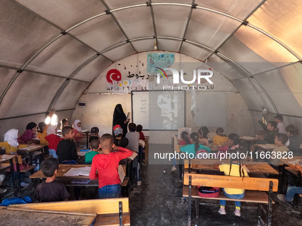 With The Approach Of Winter, Students In The Deir Ballut Camp In Rural Aleppo Study In A School Made Up Of Torn Tents, on october 13, 2024.