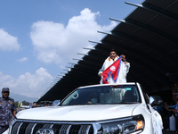 Nepalese youngest record holder climber Nima Rinji Sherpa poses with the national flag for a photo after arriving at Tribhuvan International...