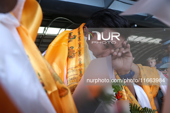 Nepalese youngest record holder climber Nima Rinji Sherpa cries after arriving at Tribhuvan International Airport in Kathmandu, Nepal, on Oc...