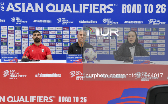 Palestine national team head coach Makram Daboub (center) and player Musab Battat (left) attend a press conference at Jassim Bin Hamad Stadi...