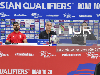 Palestine national team head coach Makram Daboub (center) and player Musab Battat (left) attend a press conference at Jassim Bin Hamad Stadi...