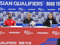 Palestine national team head coach Makram Daboub (center) and player Musab Battat (left) attend a press conference at Jassim Bin Hamad Stadi...