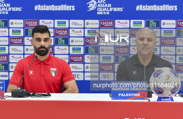 Palestine national team head coach Makram Daboub (R) and player Musab Battat (L) attend a press conference at Jassim Bin Hamad Stadium in Do...