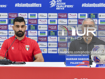 Palestine national team head coach Makram Daboub (R) and player Musab Battat (L) attend a press conference at Jassim Bin Hamad Stadium in Do...