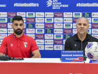 Palestine national team head coach Makram Daboub (R) and player Musab Battat (L) attend a press conference at Jassim Bin Hamad Stadium in Do...