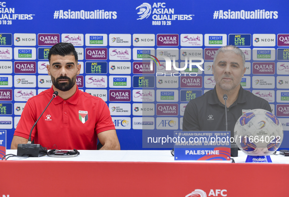 Palestine national team head coach Makram Daboub (R) and player Musab Battat (L) attend a press conference at Jassim Bin Hamad Stadium in Do...