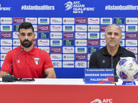 Palestine national team head coach Makram Daboub (R) and player Musab Battat (L) attend a press conference at Jassim Bin Hamad Stadium in Do...