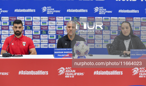 Palestine national team head coach Makram Daboub (center) and player Musab Battat (left) attend a press conference at Jassim Bin Hamad Stadi...