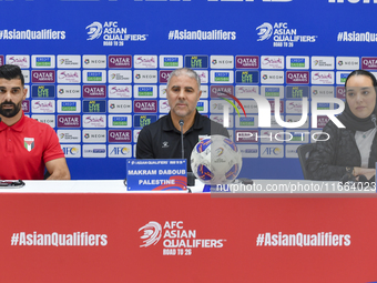 Palestine national team head coach Makram Daboub (center) and player Musab Battat (left) attend a press conference at Jassim Bin Hamad Stadi...