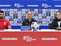 Palestine national team head coach Makram Daboub (center) and player Musab Battat (left) attend a press conference at Jassim Bin Hamad Stadi...