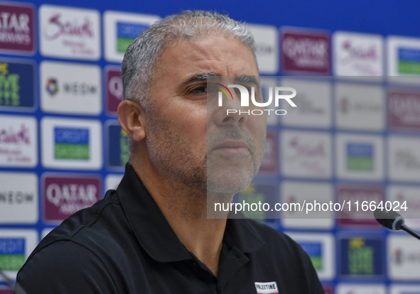 Palestine national team head coach Makram Daboub attends a press conference at Jassim Bin Hamad Stadium in Doha, Qatar, on October 14, 2024,...