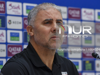 Palestine national team head coach Makram Daboub attends a press conference at Jassim Bin Hamad Stadium in Doha, Qatar, on October 14, 2024,...