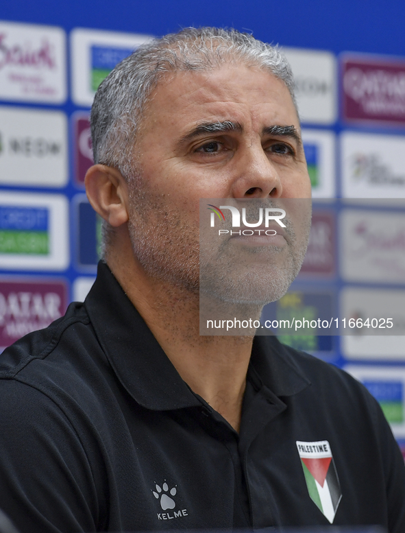 Palestine national team head coach Makram Daboub attends a press conference at Jassim Bin Hamad Stadium in Doha, Qatar, on October 14, 2024,...