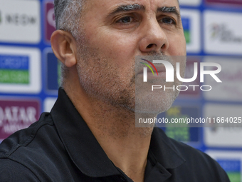 Palestine national team head coach Makram Daboub attends a press conference at Jassim Bin Hamad Stadium in Doha, Qatar, on October 14, 2024,...