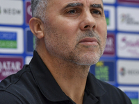 Palestine national team head coach Makram Daboub attends a press conference at Jassim Bin Hamad Stadium in Doha, Qatar, on October 14, 2024,...