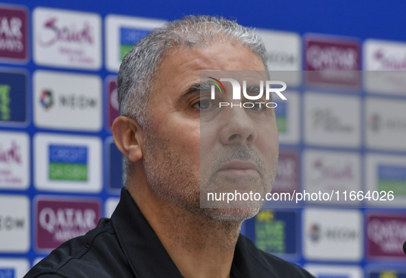 Palestine national team head coach Makram Daboub attends a press conference at Jassim Bin Hamad Stadium in Doha, Qatar, on October 14, 2024,...