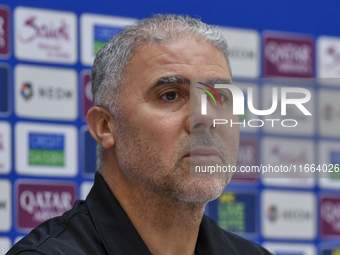 Palestine national team head coach Makram Daboub attends a press conference at Jassim Bin Hamad Stadium in Doha, Qatar, on October 14, 2024,...