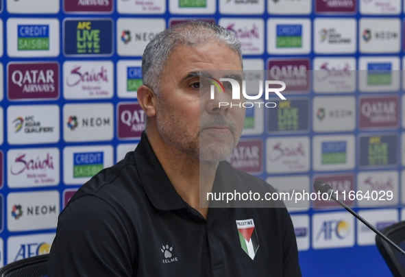 Palestine national team head coach Makram Daboub attends a press conference at Jassim Bin Hamad Stadium in Doha, Qatar, on October 14, 2024,...