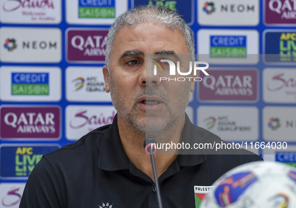 Palestine national team head coach Makram Daboub attends a press conference at Jassim Bin Hamad Stadium in Doha, Qatar, on October 14, 2024,...