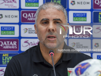 Palestine national team head coach Makram Daboub attends a press conference at Jassim Bin Hamad Stadium in Doha, Qatar, on October 14, 2024,...