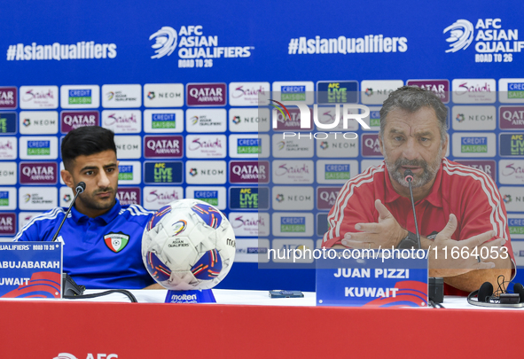 Kuwait team head coach Juan Pizzi (R) and player Redha Abujabarah (L) attend a press conference at Jassim Bin Hamad Stadium in Doha, Qatar,...