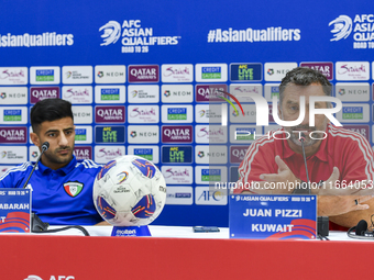 Kuwait team head coach Juan Pizzi (R) and player Redha Abujabarah (L) attend a press conference at Jassim Bin Hamad Stadium in Doha, Qatar,...