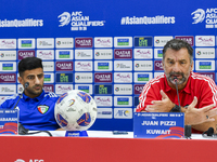 Kuwait team head coach Juan Pizzi (R) and player Redha Abujabarah (L) attend a press conference at Jassim Bin Hamad Stadium in Doha, Qatar,...