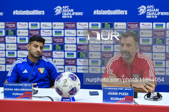 Kuwait team head coach Juan Pizzi (R) and player Redha Abujabarah (L) attend a press conference at Jassim Bin Hamad Stadium in Doha, Qatar,...