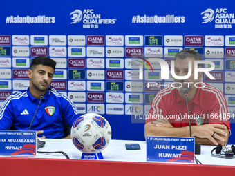 Kuwait team head coach Juan Pizzi (R) and player Redha Abujabarah (L) attend a press conference at Jassim Bin Hamad Stadium in Doha, Qatar,...