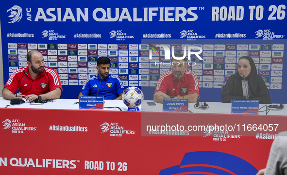 Kuwait team head coach Juan Pizzi (2nd R) and player Redha Abujabarah (2nd L) attend a press conference at Jassim Bin Hamad Stadium in Doha,...