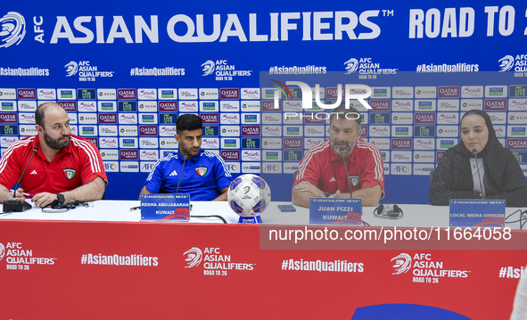 Kuwait team head coach Juan Pizzi (2nd R) and player Redha Abujabarah (2nd L) attend a press conference at Jassim Bin Hamad Stadium in Doha,...