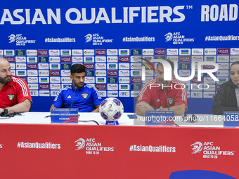 Kuwait team head coach Juan Pizzi (2nd R) and player Redha Abujabarah (2nd L) attend a press conference at Jassim Bin Hamad Stadium in Doha,...