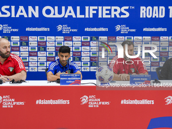 Kuwait team head coach Juan Pizzi (2nd R) and player Redha Abujabarah (2nd L) attend a press conference at Jassim Bin Hamad Stadium in Doha,...