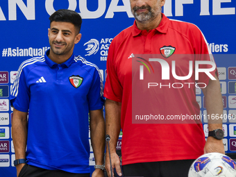 Kuwait team head coach Juan Pizzi (R) and player Redha Abujabarah (L) attend a press conference at Jassim Bin Hamad Stadium in Doha, Qatar,...