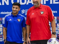 Kuwait team head coach Juan Pizzi (R) and player Redha Abujabarah (L) attend a press conference at Jassim Bin Hamad Stadium in Doha, Qatar,...