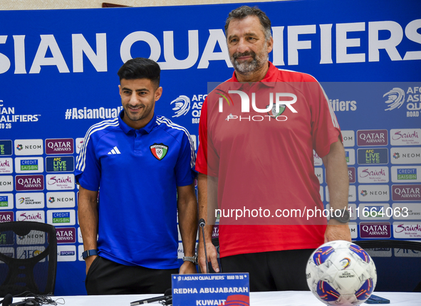 Kuwait team head coach Juan Pizzi (R) and player Redha Abujabarah (L) attend a press conference at Jassim Bin Hamad Stadium in Doha, Qatar,...