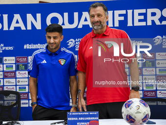 Kuwait team head coach Juan Pizzi (R) and player Redha Abujabarah (L) attend a press conference at Jassim Bin Hamad Stadium in Doha, Qatar,...