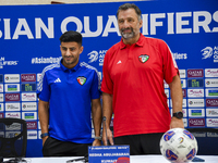 Kuwait team head coach Juan Pizzi (R) and player Redha Abujabarah (L) attend a press conference at Jassim Bin Hamad Stadium in Doha, Qatar,...