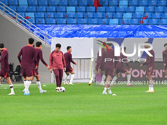 A photo taken on October 14, 2024, shows the Chinese football team during a training session at Qingdao Youth Football Stadium in Shandong p...