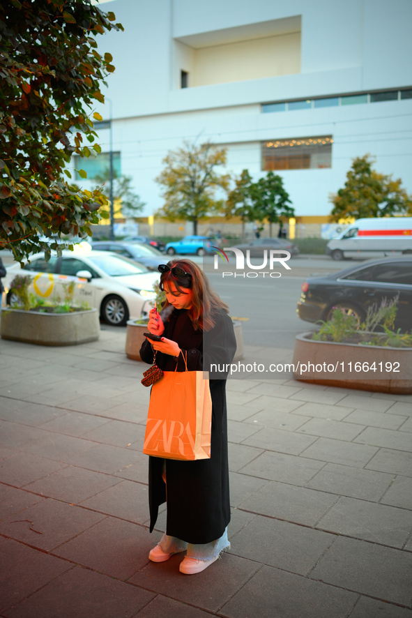 A woman smokes an e-cigarette while holding a Zara shopping bag in Warsaw, Poland on 12 October, 2024. 