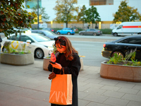 A woman smokes an e-cigarette while holding a Zara shopping bag in Warsaw, Poland on 12 October, 2024. (