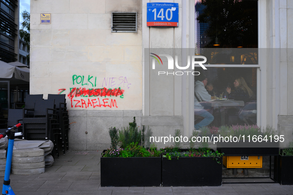 Grafitti reading "Poles are not with Israel" is seen in Warsaw, Poland on 12 October, 2024. 