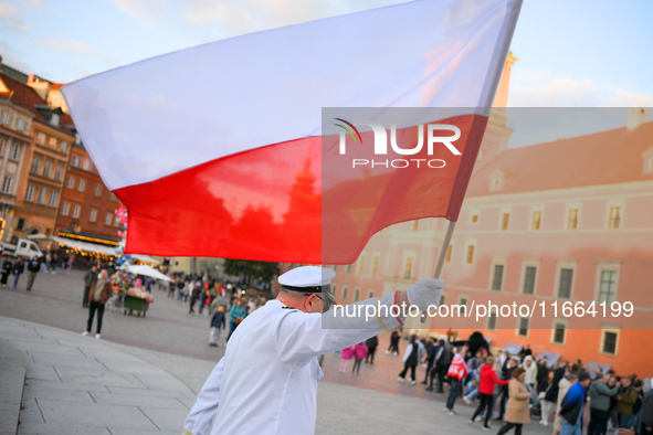 A performer waving a Polish flag is seen in Warsaw, Poland on 12 October, 2024. 