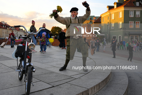 An elderly man is seen dancing on the Royal Castle square in Warsaw, Poland on 12 October, 2024. 