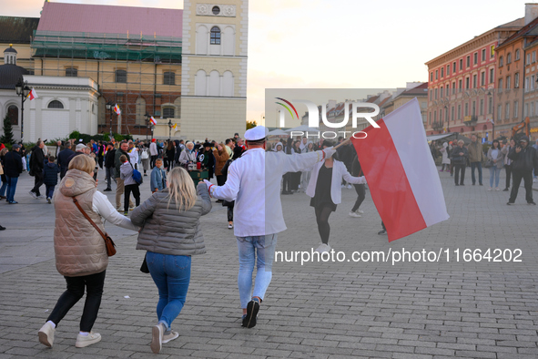 A performer waving a Polish flag is seen in Warsaw, Poland on 12 October, 2024. 