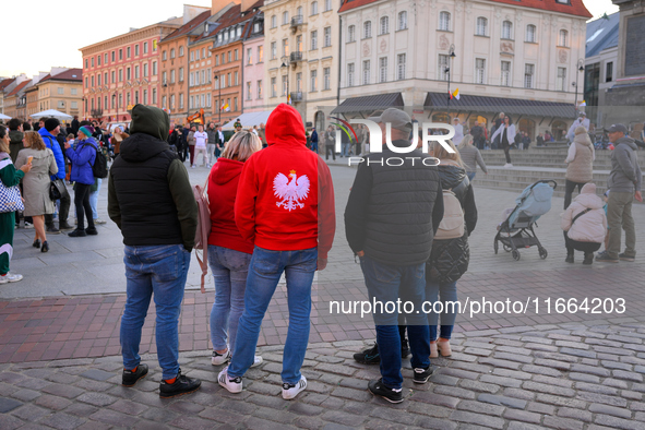 A man wearing a red sweater with a Polish eagle embroidered on it is seen in Warsaw, Poland on 12 October, 2024. 