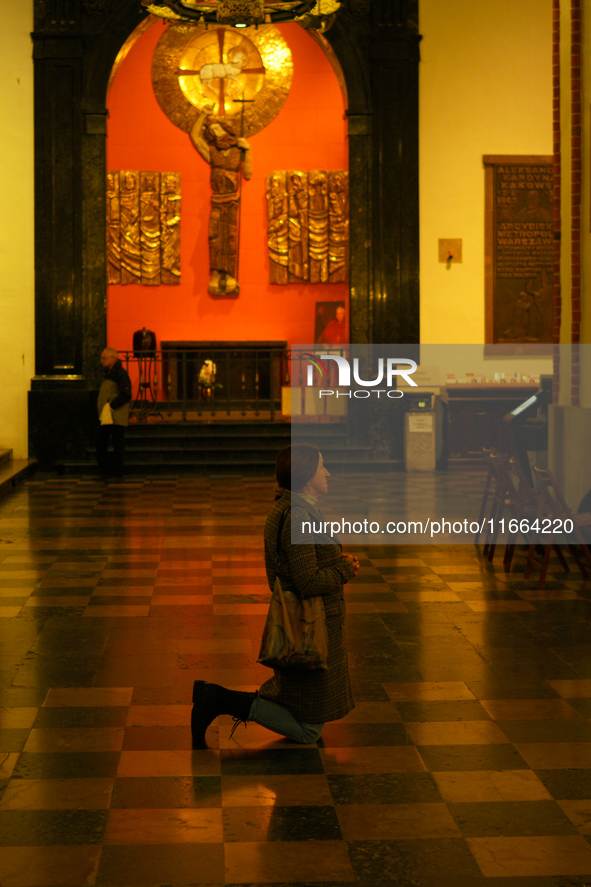 A woman is seen praying in a church in Warsaw, Poland on 12 October, 2024. 