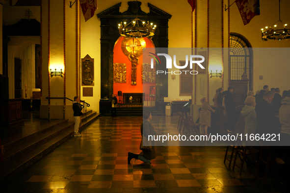 A woman is seen praying in a church in Warsaw, Poland on 12 October, 2024. 